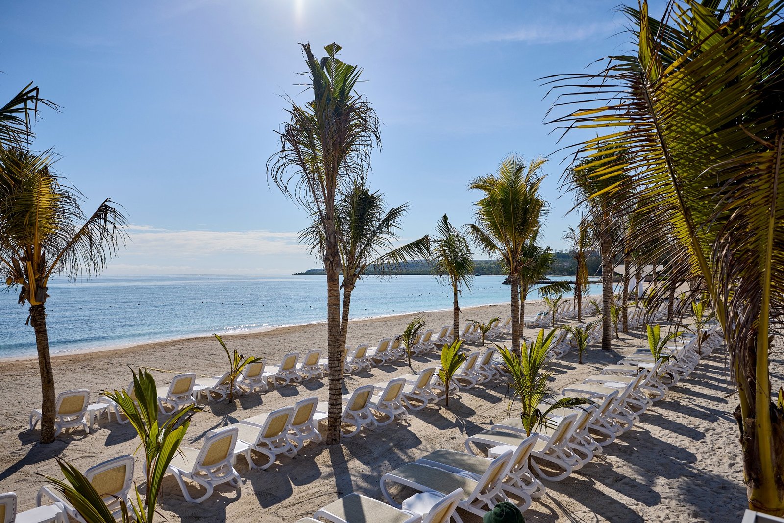 Palm-lined White Bay beach at RIU Palace Aquarelle
