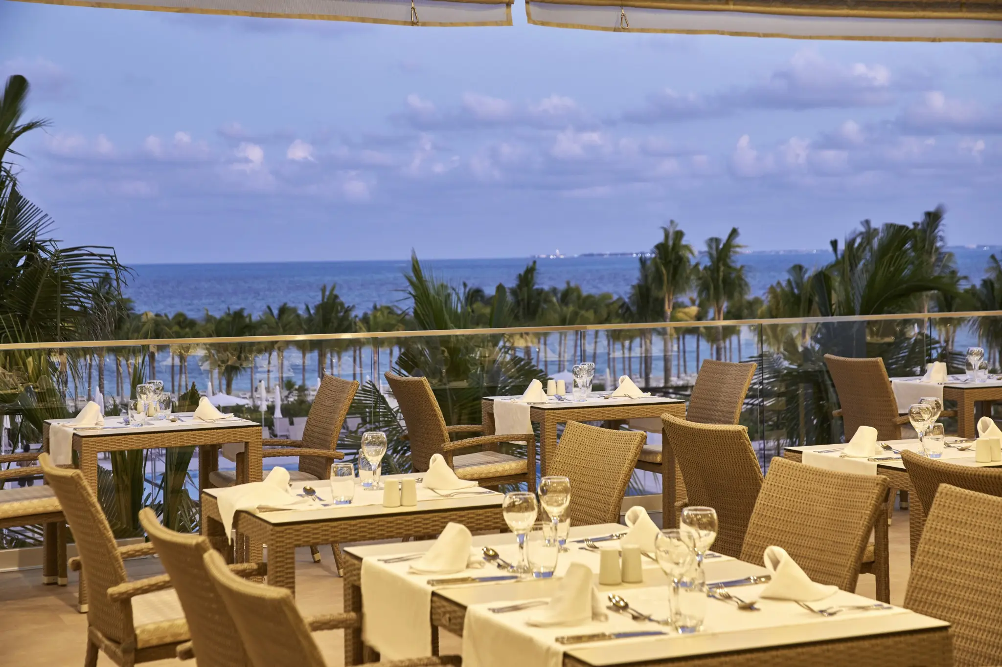 Main restaurant terrace overlooking the palms and Caribbean Sea at RIU Palace Costa Mujeres