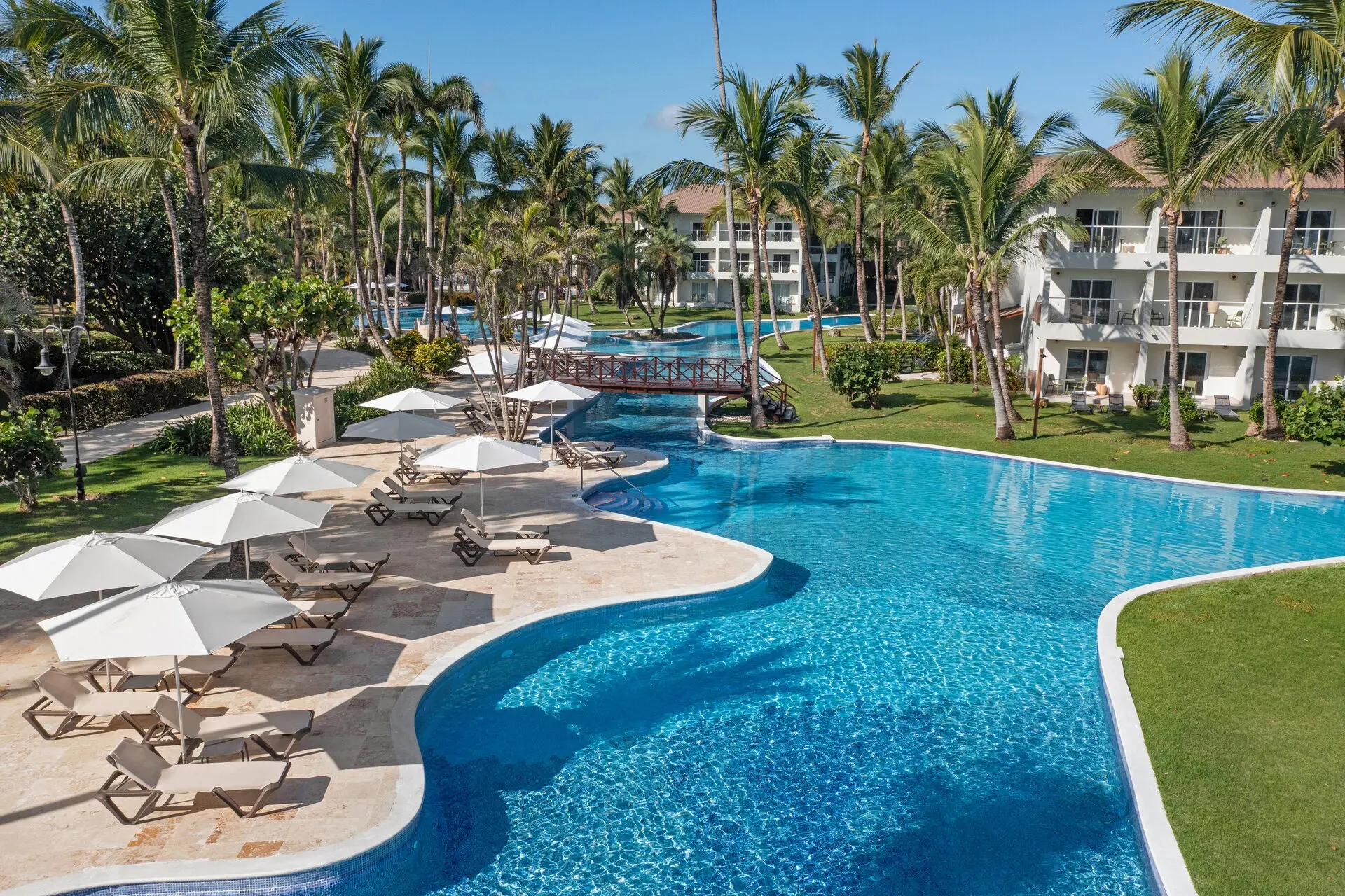 Wyndham Alltra Punta Cana sprawling pool and lazy river area surrounded by palm trees